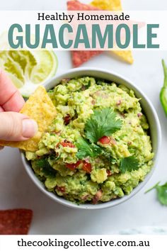 guacamole in a bowl with chips and limes