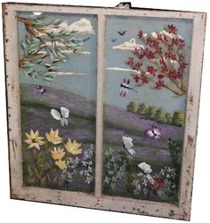 an old window with flowers and butterflies painted on it