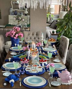 a dining room table set with plates and cups