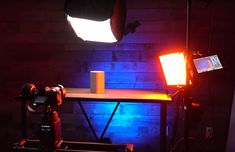 a light that is sitting on top of a table in front of a brick wall