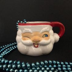 a close up of a christmas mug on a bead necklace