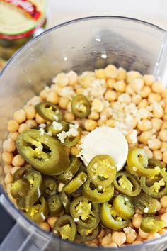 a food processor filled with beans and green peppers