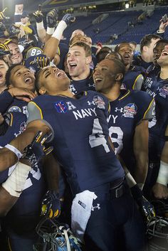 the navy football team celebrates with their trophy after winning the college football game against army