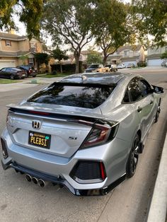 a silver car parked on the side of a road