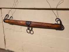 an old wooden handle hanging on a wall