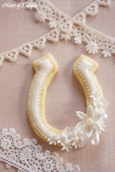 a close up of a cookie shaped like a horse shoe with flowers on the side