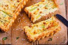 several slices of quiche on a cutting board with a knife