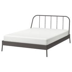 a metal bed frame with no sheets on it