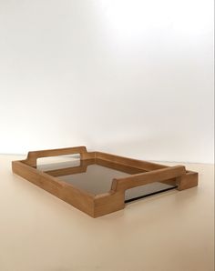 a wooden tray with mirrored sides on a table