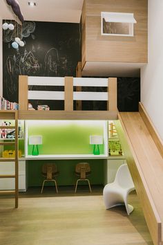 there is a loft bed and desk in this small room with stairs to the second floor