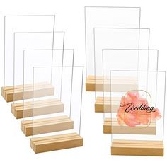 four clear acrylic boxes with wooden steps and the words wedding on them in black ink