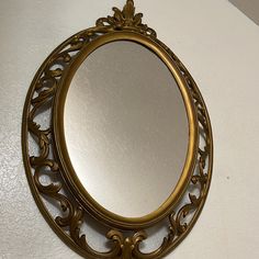 an ornate gold mirror hanging on the wall