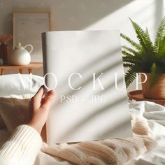 a person is laying in bed reading a book