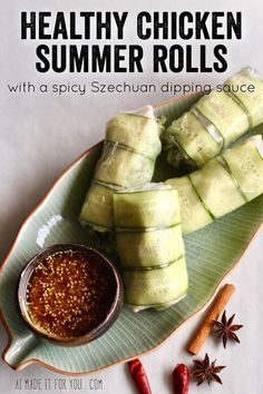 healthy chicken summer rolls with spicy zecchini dipping sauce on a green platter