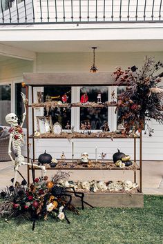 an outdoor display with fake skeletons and pumpkins