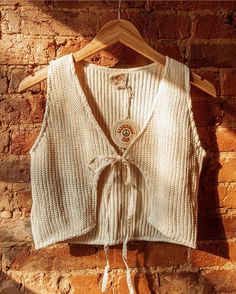 Sweet boho style knit vest, lovingly crafted from 100% GOTS certified organic unbleached cotton. This cropped vest from Gardenbelle Shop embraces a laid-back beachy vibe, offering a perfect lightweight layer without being too hot. Designed for the conscious fashionista, it beautifully embodies our commitment to sustainability and ethical fashion. Elevate your wardrobe with this versatile piece that's both stylish and comfortable, perfect for any casual outing or a sunlit stroll. Add a touch of o Beige Cotton V-neck Knit Top, Bohemian Knitted V-neck Top, Bohemian V-neck Knitted Top, Summer Cotton V-neck Vest, Bohemian Sleeveless Knit Top, Bohemian Cotton Crochet V-neck Top, Casual Knit Vest For Beach, Beige V-neck Cotton Knit Top, Beige Cotton Vest Top