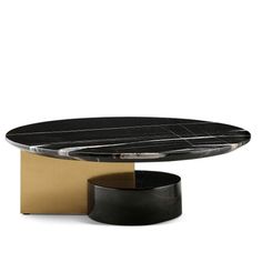 a black and gold coffee table with an oval marble top, on a white background