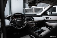 the interior of a vehicle with dashboard, steering wheel and dash lights in black and white