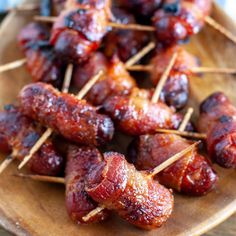 bacon wrapped in toothpicks on a wooden plate