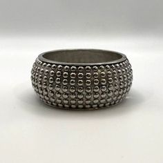 Add a touch of vintage bling to your wrist with this Chunky Silver Studded Bangle.  * Hinged closure for easy wear * Studded design for extra sparkle * Diameter: 2 1/2  inches * Width: 1.25 inches Condition: Pre-Owned Good Silver Beaded Bangle For Party, Silver Beaded Bling Bangle Bracelets, Adjustable Silver Bling Cuff Bracelet, Adjustable Silver Bangle With Bling, Silver Bling Beaded Bangle Bracelet, Silver Adjustable Bling Cuff Bracelet, Adjustable Metal Cuff Bracelet With Bling, Silver Metal Bangle With Bling, Silver Bling Adjustable Cuff Bracelet