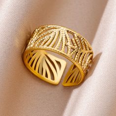 a gold ring sitting on top of a white cloth