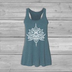 Women's graphic tank top screen printed with an Lotus Henna design. Flattering Bella Flowy silhouette with a relaxed draped fit made in an exceptionally soft fabric that is light weight and stretchy. The back is detailed with racerback cinching. You will love this tank for yoga, casual wear or lounging around the house.Available with white or black ink. SIZE NOTE- See image chart for colors and detailed size specFIT NOTE- True to size Relaxed Fit.  Follow the measurement chart for best fit!- Bel Lotus Henna, Hippie Tank Tops, Moon Clothing, Womens Tank Tops, Boho Yoga, Yoga Tank, Yoga Tank Tops, Flowy Tank Tops, Measurement Chart