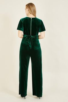 A fabulous festive fit, this velvet jumpsuit comes in a deep, stunning green, with a flattering wrap style top, wide legged trousers, a fitted waistband and flared angel sleeves. Pair with strappy heels or wedges to complete the look. Wide Legged Trousers, Green Angel, Wrap Jumpsuit, Angel Sleeves, Velvet Jumpsuit, Green Jumpsuit, Angel Sleeve, Floral Shirt Dress, Jumpsuit With Sleeves