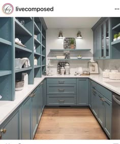 an image of a kitchen with blue cabinets and white counter tops on the bottom shelf