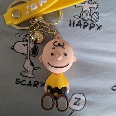 a keychain with a cartoon character on it sitting next to a pair of scissors