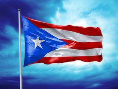 the puerto rican flag is flying high in the sky