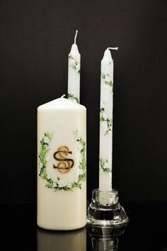 two candles sitting next to each other on a table