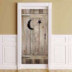 an open door with the moon and stars painted on it