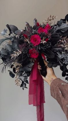 a woman holding a bouquet of flowers in her hands