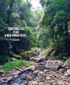 a river running through a lush green forest filled with rocks and trees, with a quote written