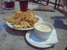 two plates with food on them sitting on a table next to a cup and saucer