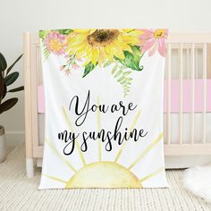 a baby crib with a blanket that says you are my sunshine