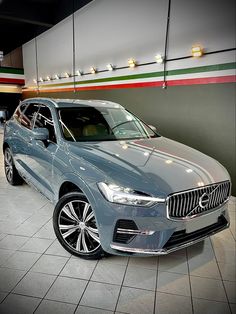 a blue car is parked in a showroom