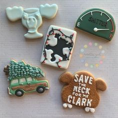 decorated cookies are arranged on top of a table