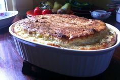 a casserole dish sitting on top of a wooden table