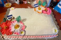 a large white cake with flowers on it