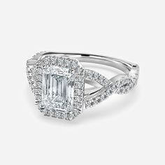 an emerald cut diamond engagement ring with twisted band