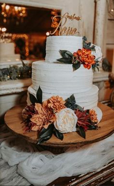 a white wedding cake with flowers on top