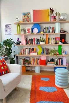 a living room filled with lots of furniture and bookshelves on top of shelves