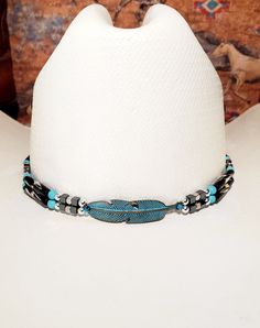 Hat Band with Hematite and Black/White Hairpipe Beads (or lBack or GoldenAmber Buffalo Horn Hairpipe beads) or and either silver or turquoise feather centerpiece, hematite and silver plated beads.  Turquoise Feather has turquoise howlite accent beads and Silver Feather has Hematite Accent beads (see pictures).  Includes adjustable deerskin tie in back.  Measures approximately 22.5" in length.  Designed and Handmade by me!  Shown on a size 7 hat - Hats are not included.     Can be made with the following Hairpipe Beads:  Black Horn, Black/White, GoldenAmber, Red, Bone, or Antique Bone (just put color in comments) or message me. Tie in back can be:  Black, Natural, Rusty Brown or Brown - just ask! See my other listings for over 160 different handmade designs:  https://www.etsy.com/shop/BlueE Adjustable Silver Hat Bands For Festivals, Cowboy Hat Bands, Feather Centerpieces, Red Bone, Boot Bracelet, Decorative Beads, Western Hats, Silver Feather, Bone Beads