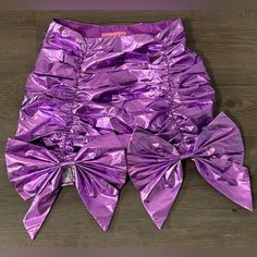 This Mini Skirt Has A Metallic Construction, Ruching, Bow Detailing, And A Side Zipper Closure. Fitted Purple Mini Skirt Skort, Chic Purple Ruffled Mini Skirt, Purple Miniskirt, Dolls Kill Spongebob, Dolls Kill Skirt, Sugar Thrillz, Dolls Kill, Side Zipper, Color Purple