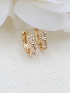 Beautiful solid 14k yellow gold Bagguete and round CZ Huggies Earrings. Perfect for everyday and every occasion. Modern, unique and versatile. Will match any outfit. 14k gold will not tarnish or rust. Materials: 14k gold, cubic zirconia diamonds Diameter: 12.5mm Width: 3mm Weight: 1.5 Grams 14k gold stamped Fast shipping Follow us for more fine 14k Gold jewelry Contact me with all your questions i will be happy to help Gold Baguette Diamond Earrings For Anniversary, Anniversary Gold Baguette Diamond Earrings, 14k Gold Hoop Earrings With Baguette Diamonds, Classic Gold Diamond Earrings With Baguettes, Gold Cubic Zirconia Diamond Earrings Baguette Cut, Gold Baguette Cut Cubic Zirconia Diamond Earrings, Classic Gold Diamond Earrings With Baguette Diamonds, Classic Gold Baguette Diamond Earrings, Elegant Gold Baguette-cut Earrings