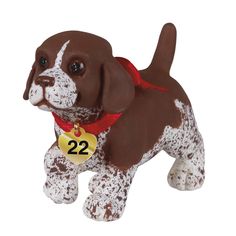 a brown and white dog figurine with a red ribbon around it's neck