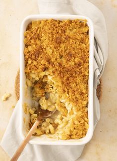 a casserole dish filled with macaroni and cheese on top of a table