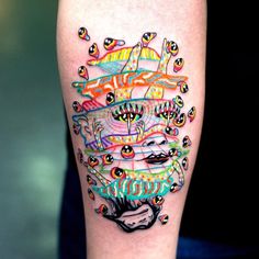 a colorful tattoo on the leg of a person