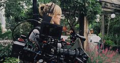 a woman standing in front of a camera